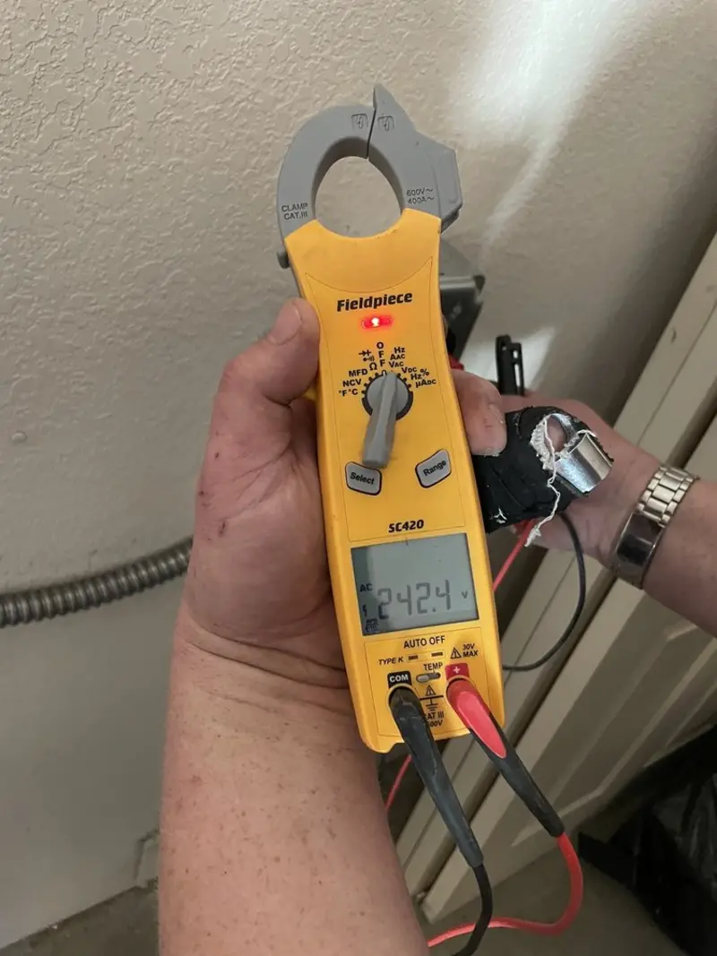 Voltage testing with clamp meter during Electrical Installation Services in Williamsburg
